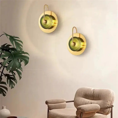 Decorbites brass and green glass wall lamp pair with circular backplates and curved arms on Tampa Home & Garden Store