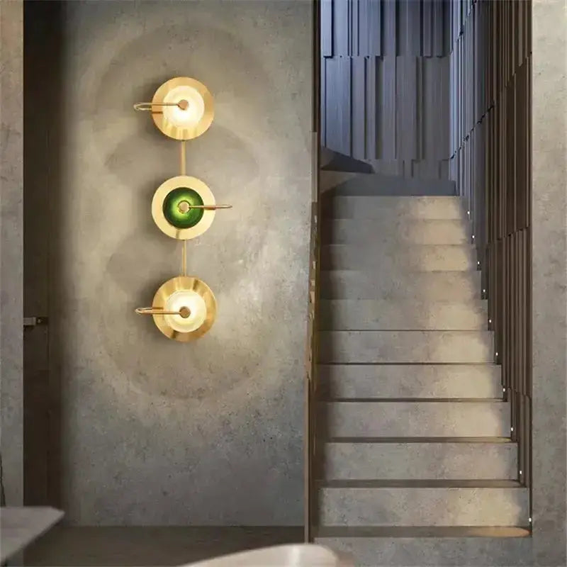 Decorbites modern brass wall lamp with three circular sconces and green glass center on Tampa Home & Garden Store