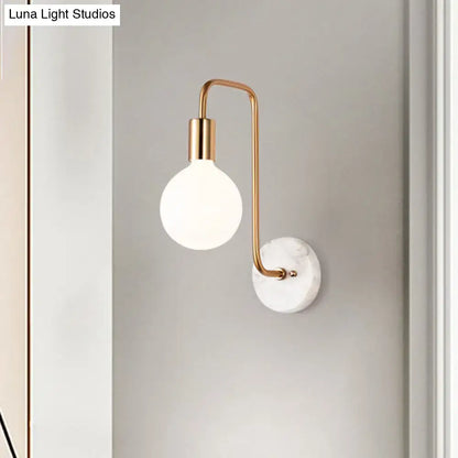 Decorbites White Glass Sphere Marble Sconce with gold curved arm on marble wall on Tampa Home & Garden Store