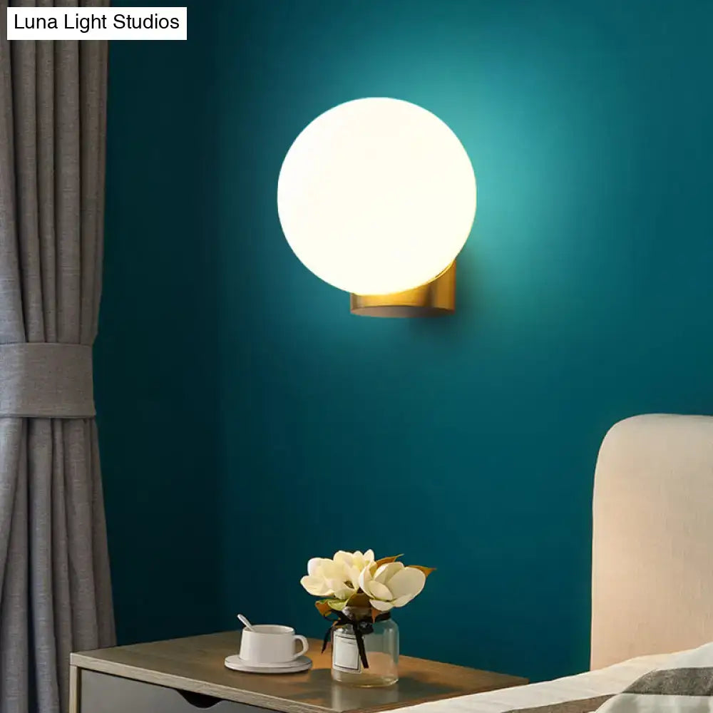 Brass Opal Wall Sconce globe white opal shade with gold mount by Decorbites on teal bedroom wall on Tampa Home & Garden Store