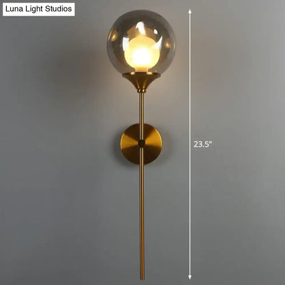 Brass Smoke Glass Wall Light by Decorbites; smoky glass globe, brass stem, 23.5in height on Tampa Home & Garden Store