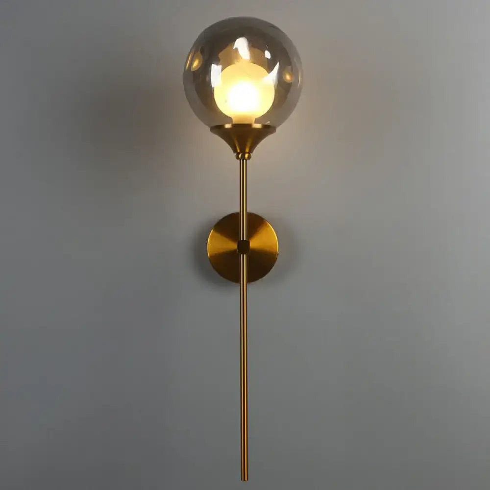 Brass smoke glass wall light sconce with gold finish and clear globe by Decorbites on Tampa Home & Garden Store