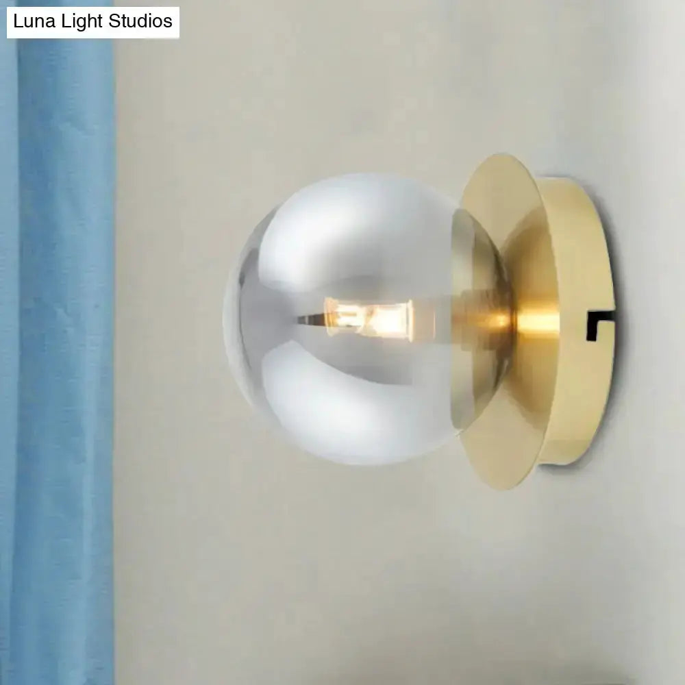 Modern brass wall lamp with smoky glass globe shade and exposed filament bulb Luna Light Studios on Tampa Home & Garden Store