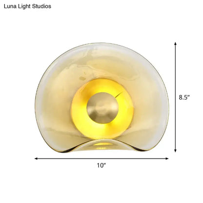 Brass tan glass refined wall sconce by Decorbites with amber glow on Tampa Home & Garden Store