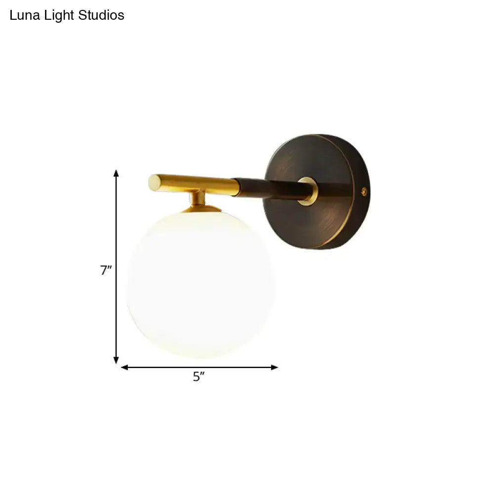Brass glass globe sconce by Decorbites, 7in tall with white glass globe on Tampa Home & Garden Store