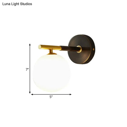 Brass glass globe sconce by Decorbites, 7in tall with white glass globe on Tampa Home & Garden Store