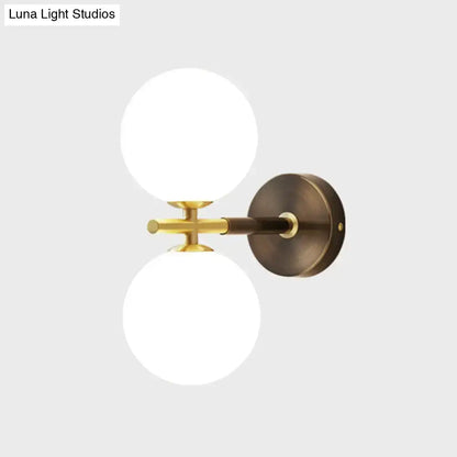 Brass glass globe double sconce with bronze backplate by Decorbites on Tampa Home & Garden Store