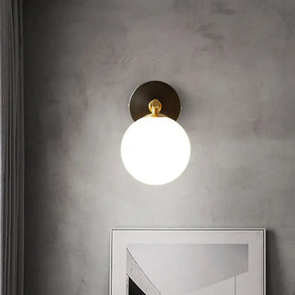 Brass Glass Globe Sconce by Decorbites, wall-mounted with brass backplate and frosted globe on Tampa Home & Garden Store