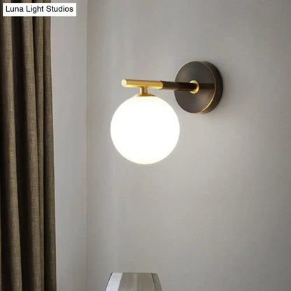 Brass glass globe sconce by Decorbites, wall-mounted with round backplate on Tampa Home & Garden Store