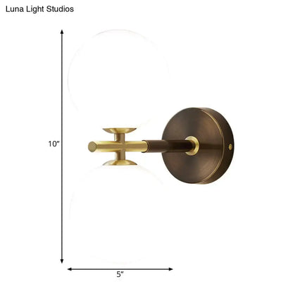 Brass Glass Globe Sconce by Decorbites, wall-mounted bronze backplate and clear glass globe on Tampa Home & Garden Store