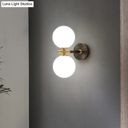 Brass Glass Globe Sconce with dual white globes on brass bar and round backplate Decorbites on Tampa Home & Garden Store