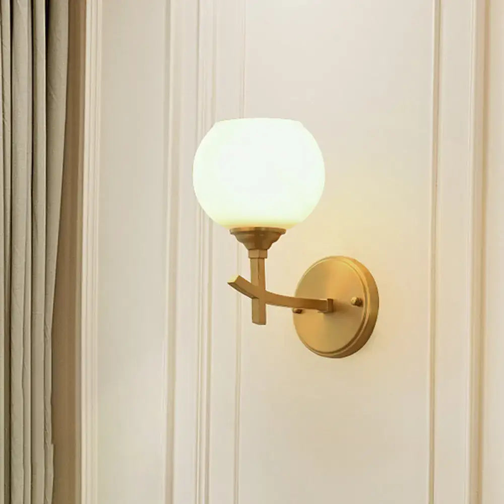 Brass opal glass wall sconce dual-mount style with globe shade on Tampa Home & Garden Store