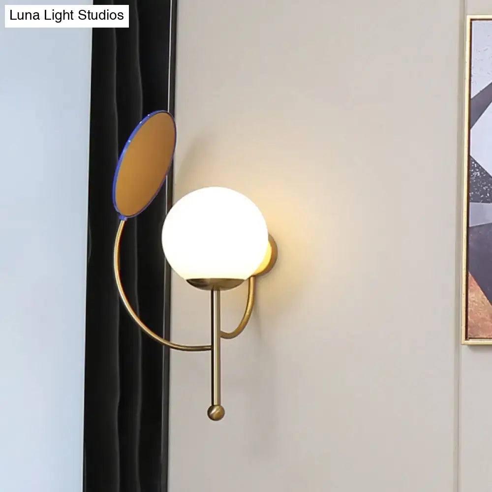Brass blue frosted sconce by Decorbites with white glass globe and blue disk wall mount on Tampa Home & Garden Store