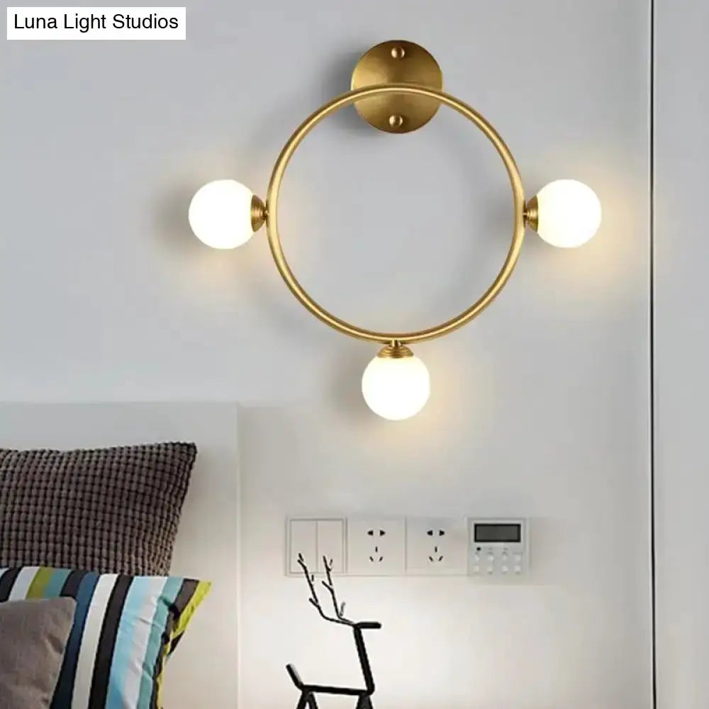 Modern brass circular wall light fixture with three glass globe shades Decorbites bedroom on Tampa Home & Garden Store