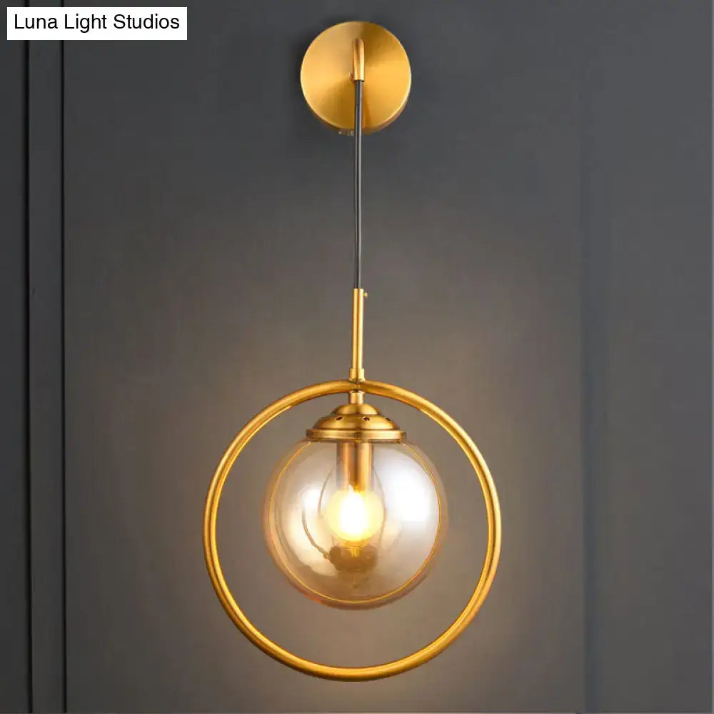 Brass circular wall lamp with gold finish and clear glass globe by Decorbites on Tampa Home & Garden Store