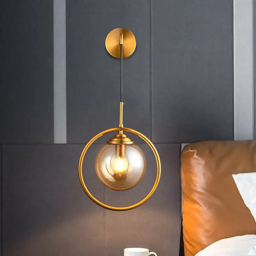 Brass circular wall lamp with glass globe and exposed bulb, gold finish on Tampa Home & Garden Store