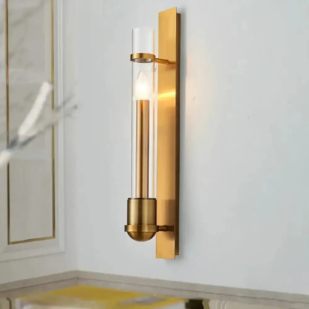 Modern brass wall sconce with clear cylindrical glass tube and exposed bulb Decorbites on Tampa Home & Garden Store