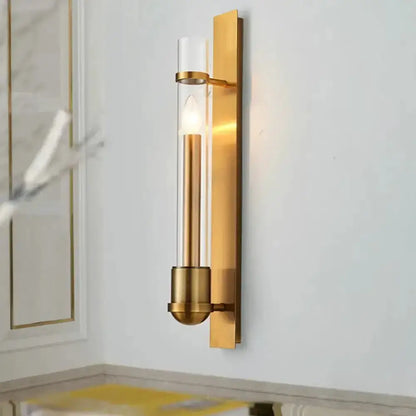Modern brass wall sconce with clear cylindrical glass tube and exposed bulb Decorbites on Tampa Home & Garden Store