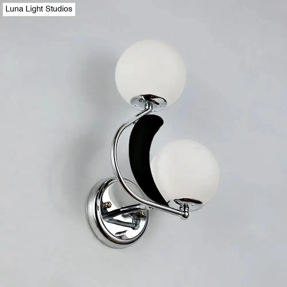 Chrome crescent wall sconce with two frosted glass globes for bedroom lighting on Tampa Home & Garden Store