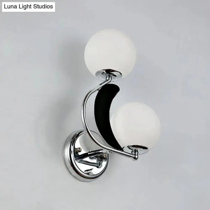 Chrome crescent wall sconce with two frosted glass globes for bedroom lighting on Tampa Home & Garden Store