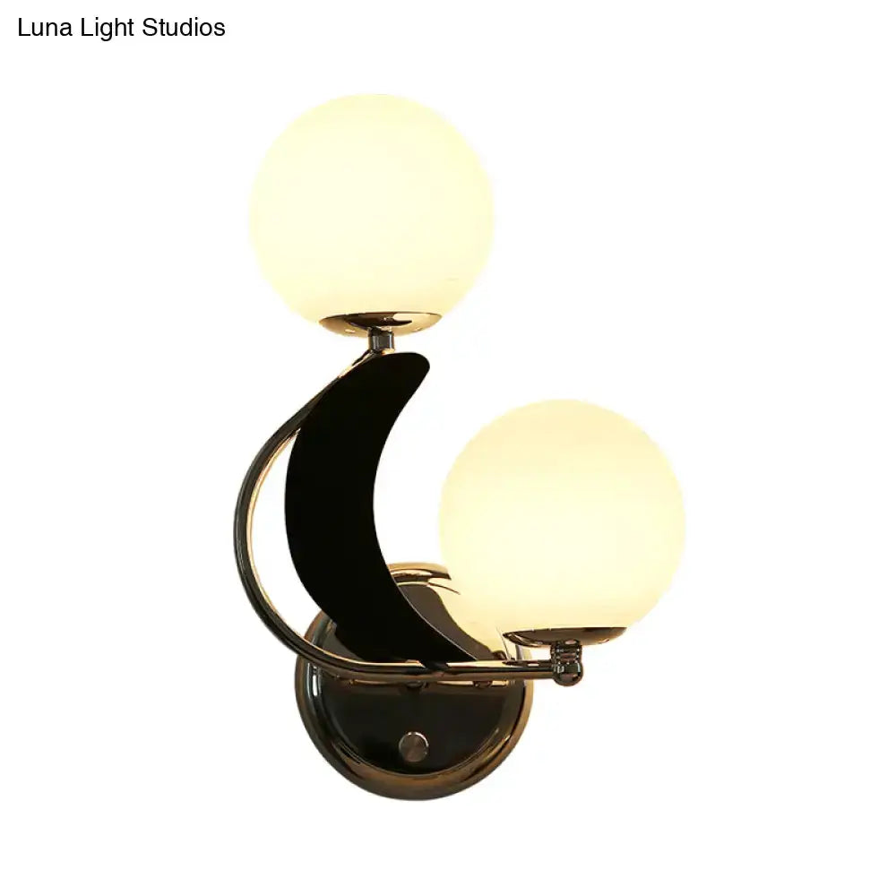 Modern brass crescent wall light with dual glass globes Decorbites bedroom sconce on Tampa Home & Garden Store
