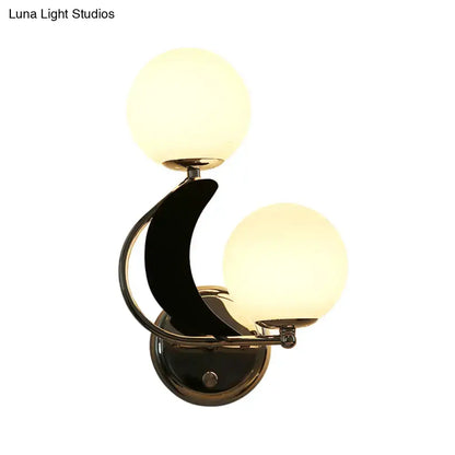 Modern brass crescent wall light with dual glass globes Decorbites bedroom sconce on Tampa Home & Garden Store