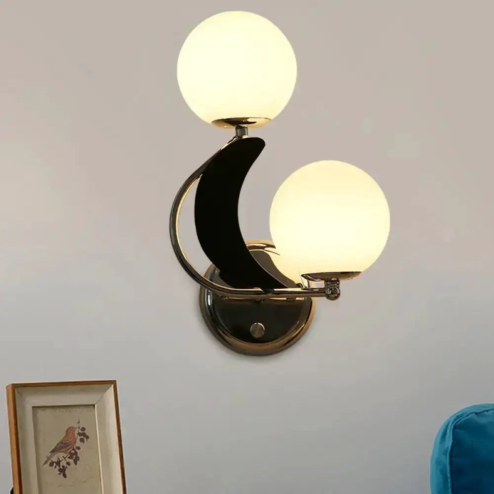 Decorbites modern brass crescent wall sconce with two frosted glass globe shades on Tampa Home & Garden Store