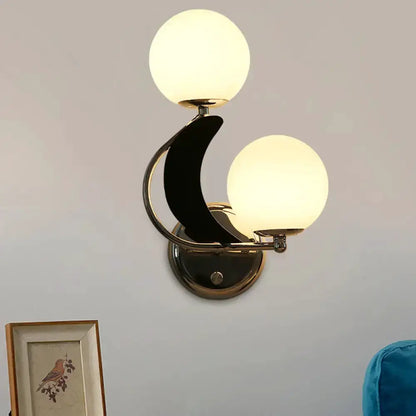 Decorbites modern brass crescent wall sconce with two frosted glass globe shades on Tampa Home & Garden Store