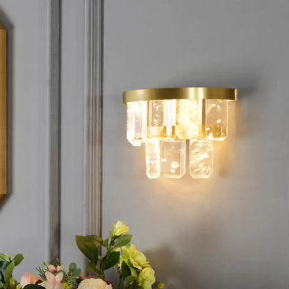Brass crystal wall sconce with hanging glass prisms, warm gold glow Decorbites on Tampa Home & Garden Store