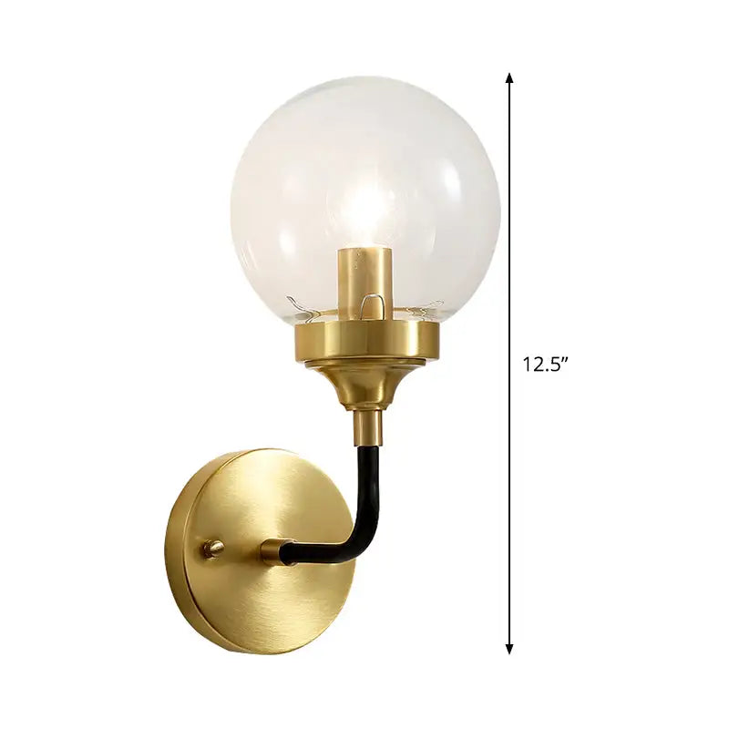 Brass curved wall sconce with clear glass globe by Decorbites on Tampa Home & Garden Store