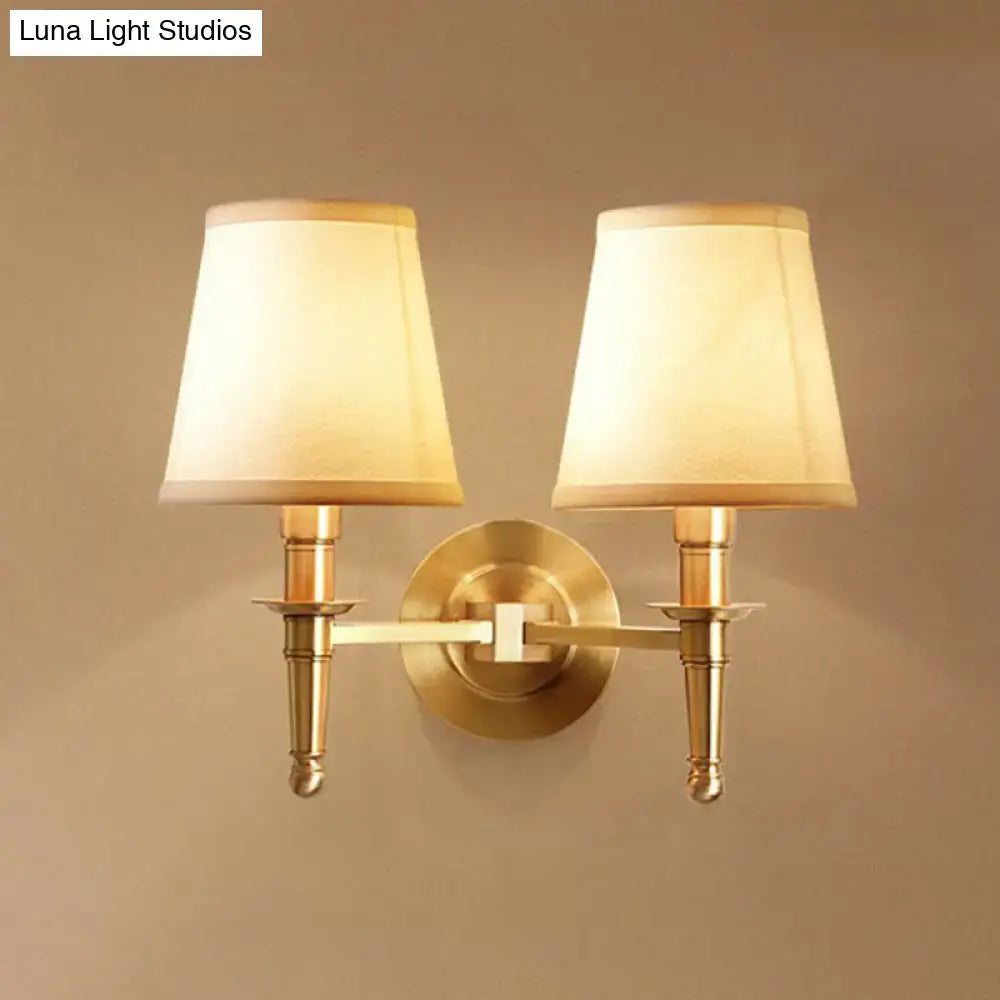 Brass fabric wall sconce pair by Decorbites with cream shades and brass backplate on Tampa Home & Garden Store