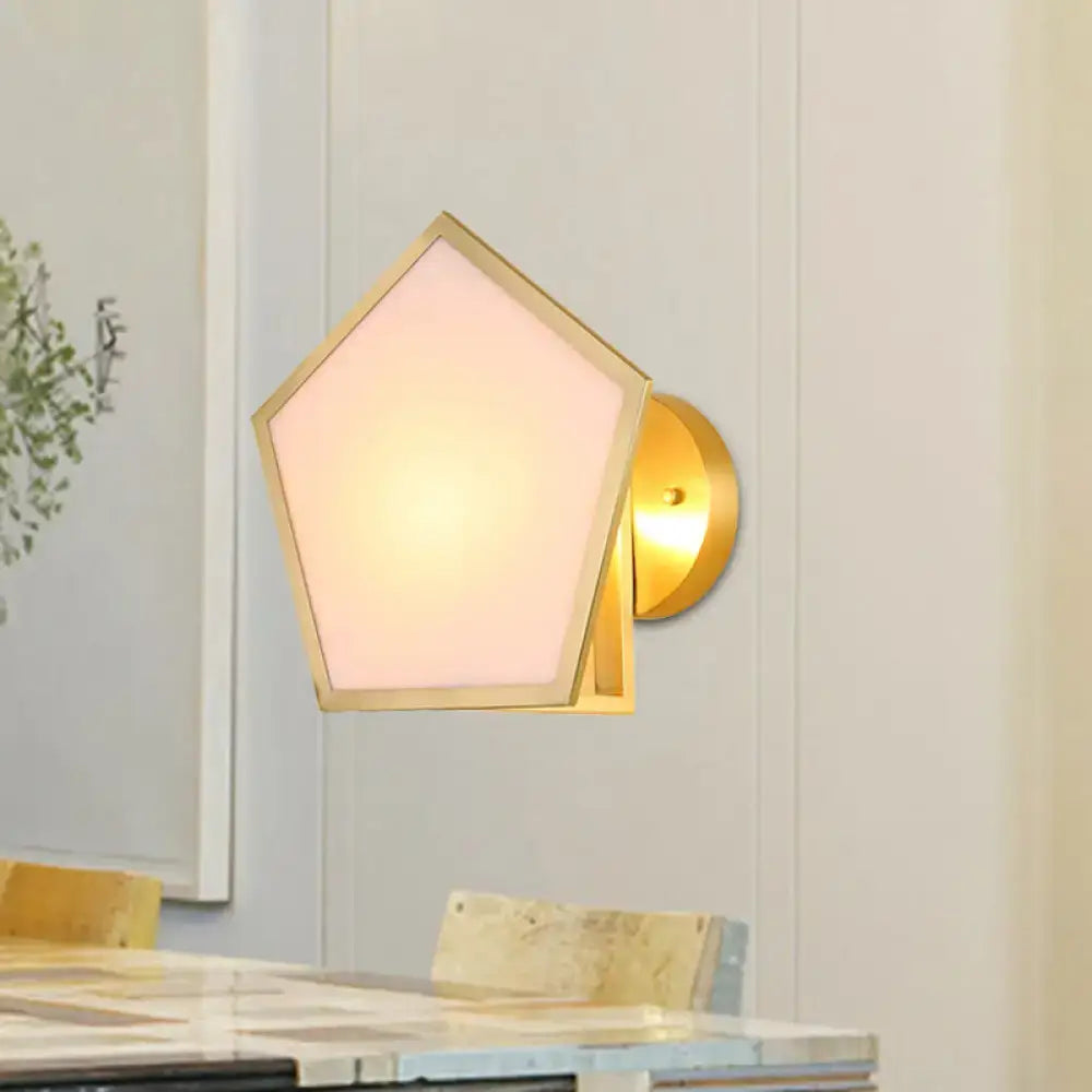 Brass pentagon wall lamp with frosted white shade on circular backplate on Tampa Home & Garden Store