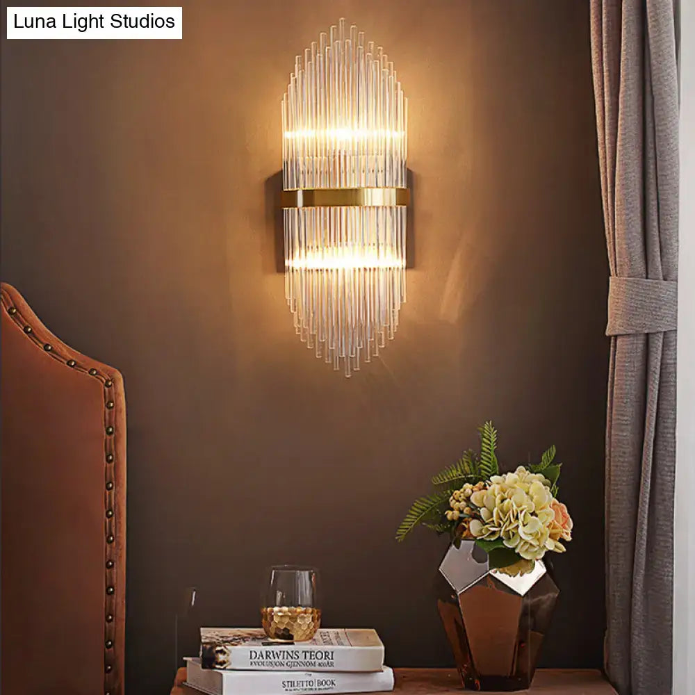 Brass fluted glass sconce with trailing arm design mounted on brown wall on Tampa Home & Garden Store