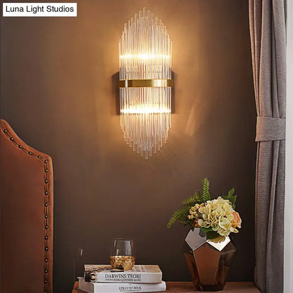 Brass fluted glass sconce with trailing arm design mounted on brown wall on Tampa Home & Garden Store