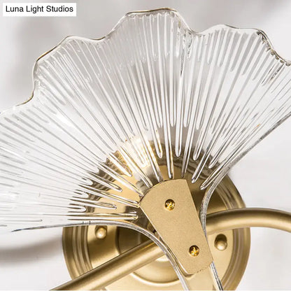 Brass Ginkgo Wall Sconce by Decorbites with clear ribbed glass shade and gold hardware on Tampa Home & Garden Store