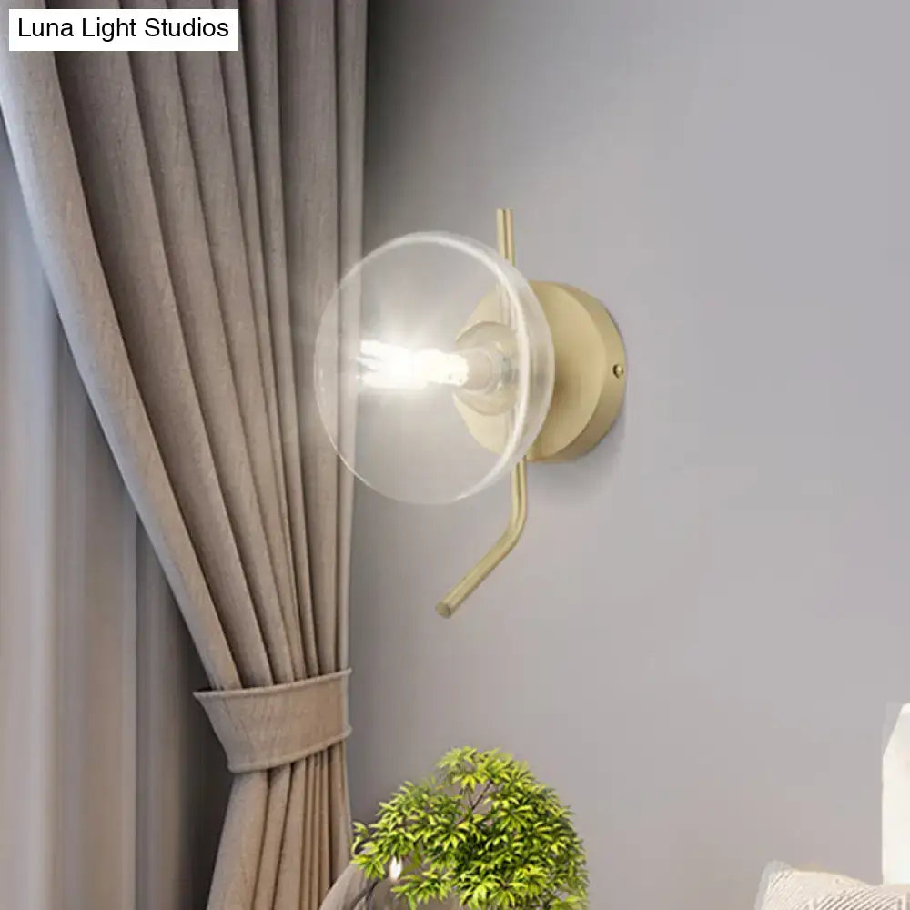 Brass dome wall sconce with clear glass shade and exposed bulb by Decorbites on gray wall Tampa Home & Garden Store