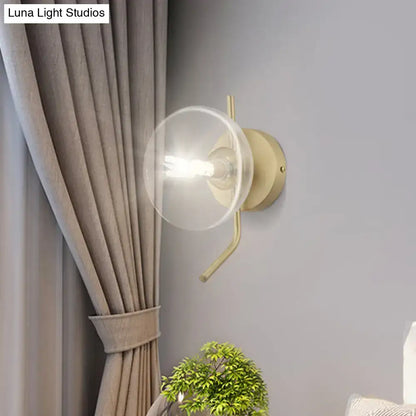 Brass dome wall sconce with clear glass shade and exposed bulb by Decorbites on gray wall Tampa Home & Garden Store