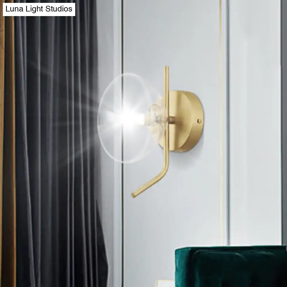 Brass dome wall sconce with clear glass shade and curved arm by Decorbites on Tampa Home & Garden Store