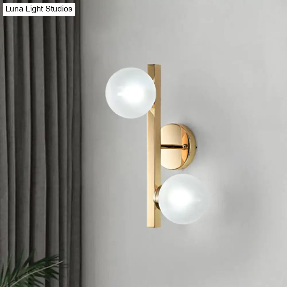 Brass dual-globe opal wall light with two frosted glass globes on Tampa Home & Garden Store