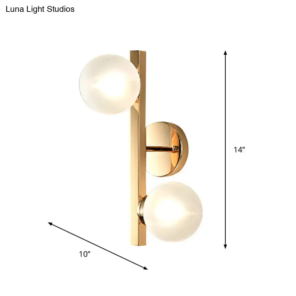 Brass dual globe opal wall light by Decorbites with two frosted glass globes on a vertical bar, 14 inches tall on Tampa Home & Garden Store