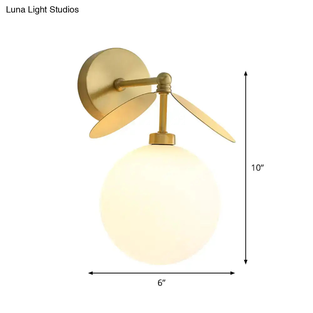 Modern brass leaf wall lamp with cream glass globe by Decorbites, 10in tall 6in wide on Tampa Home & Garden Store