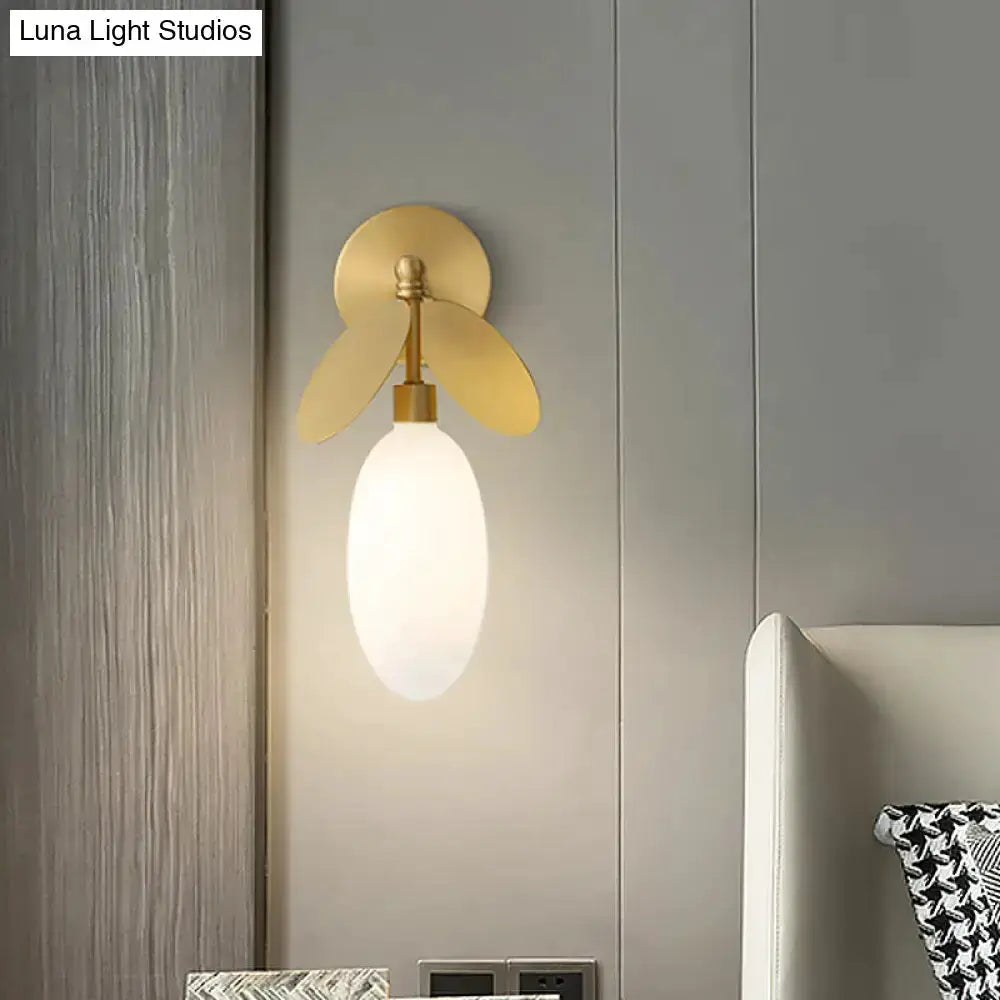 Modern brass leaf wall lamp with cream glass shade bedroom sconce on Tampa Home & Garden Store