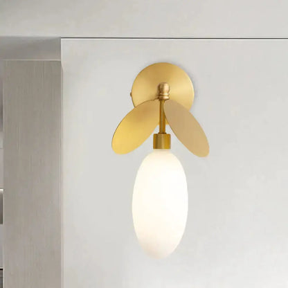 Modern brass leaf wall lamp with cream glass shade, bedroom sconce on Tampa Home & Garden Store