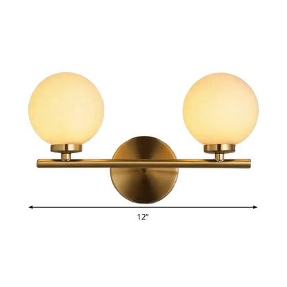 Decorbites brass two-globe wall sconce with frosted glass shades, 12 inches wide on Tampa Home & Garden Store