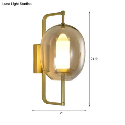 Gold oval glass hallway sconce by Decorbites with brass finish and amber shade on Tampa Home & Garden Store