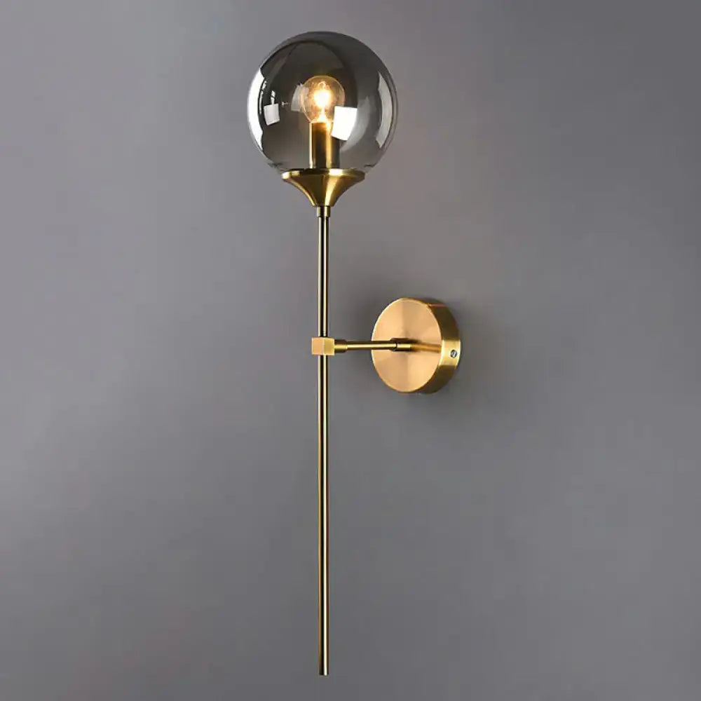 Brass pencil adjustable arm wall sconce by Decorbites with clear glass globe shade on Tampa Home & Garden Store