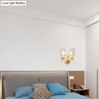 Brass water-glass sconce dual-light with glass shades above bed; Luna Light Studios on Tampa Home & Garden Store