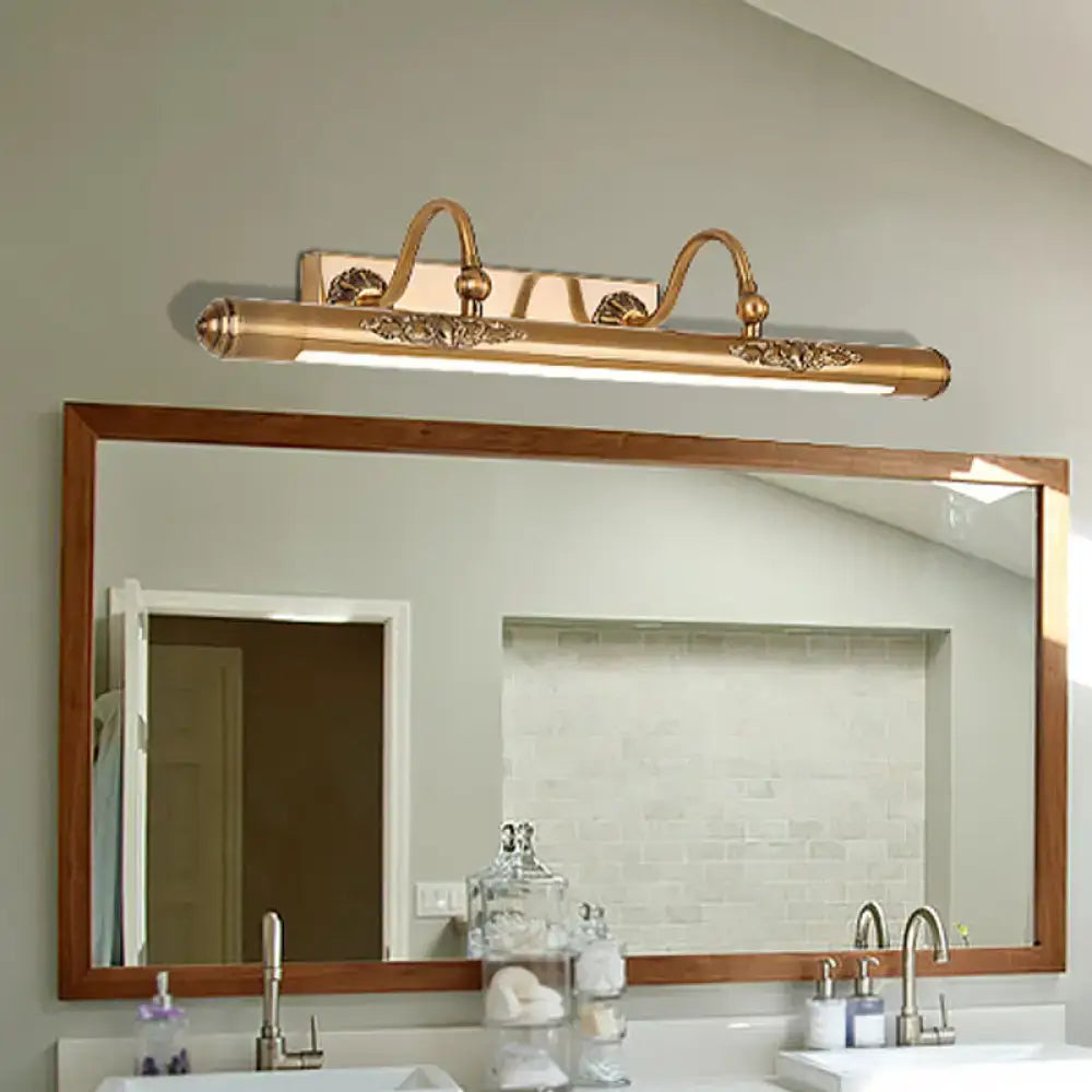 Brass scrollwork vanity light by Decorbites above bathroom mirror on Tampa Home & Garden Store