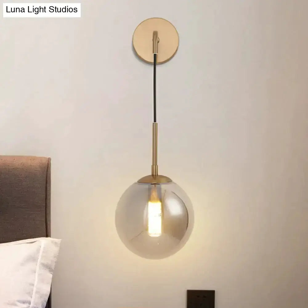 Modern brass smoked-glass ball wall lamp with hanging cord by Decorbites for bedroom lighting on Tampa Home & Garden Store
