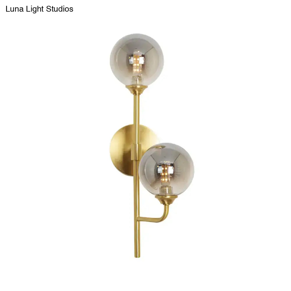 Decorbites brass sphere bathroom sconce with two clear glass globes on vertical brass mount on Tampa Home & Garden Store